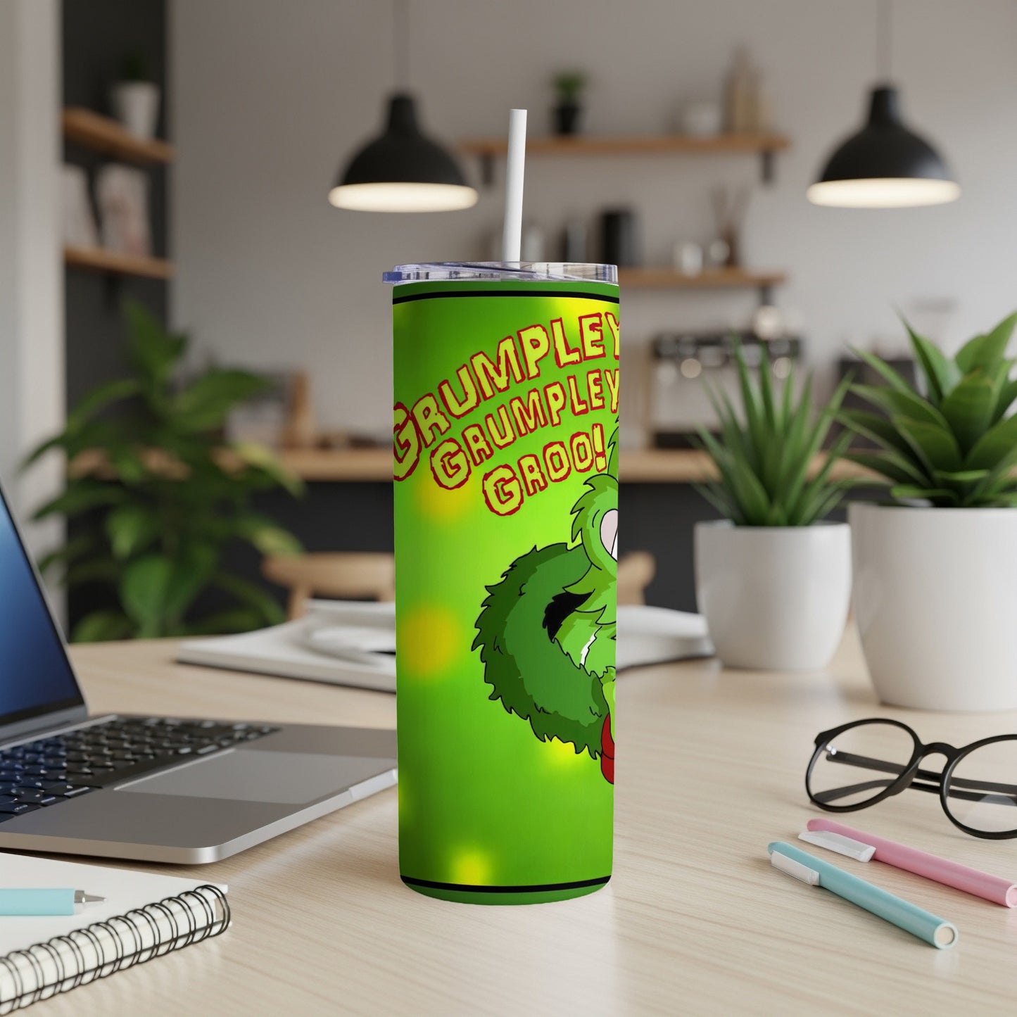 Green Grumbley character on a lime green tumbler with a straw.