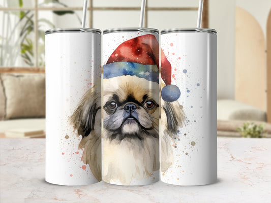 Santa hat wearing pug dog tumbler with watercolor splatter effect.