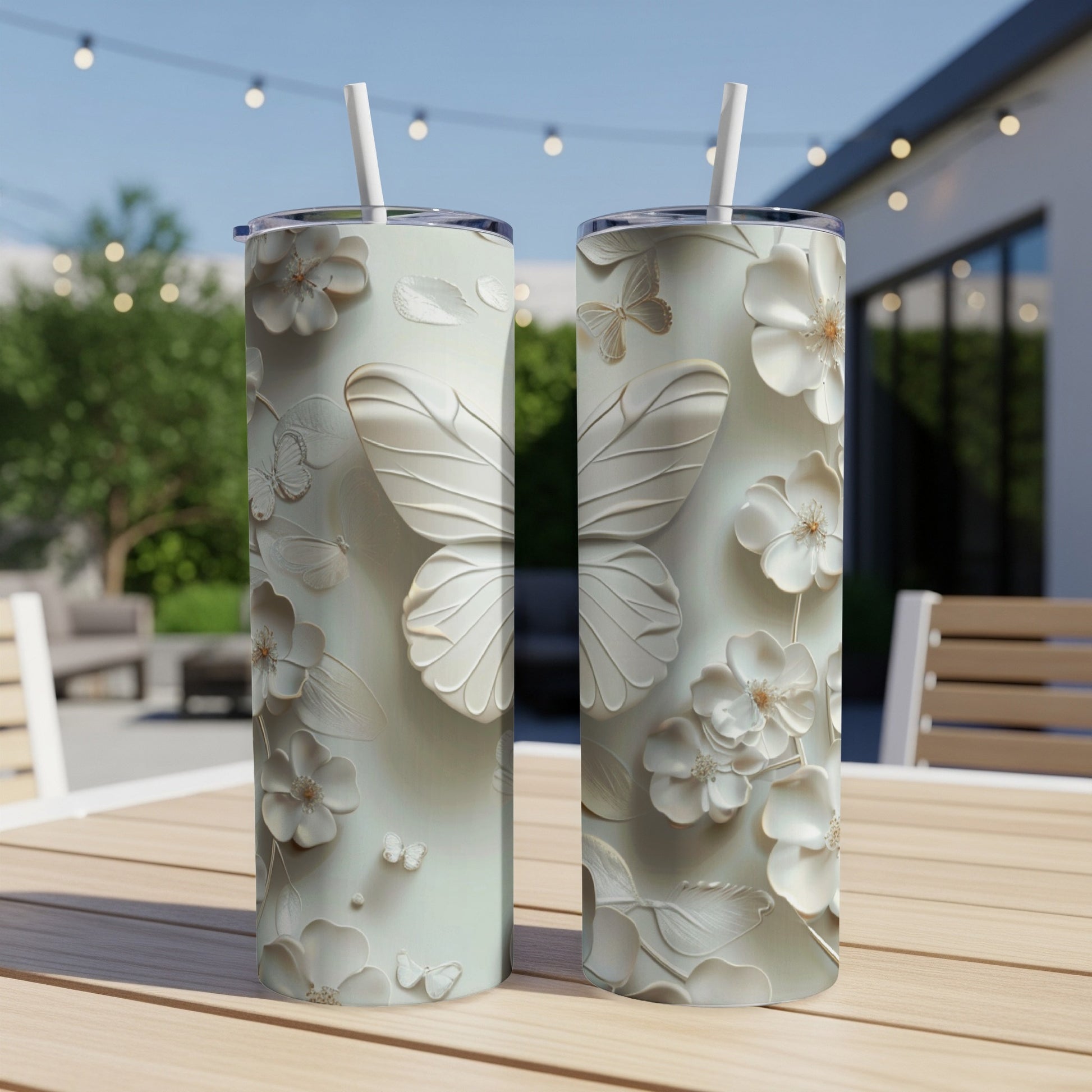 Two pale green tumblers with embossed butterfly and floral designs.
