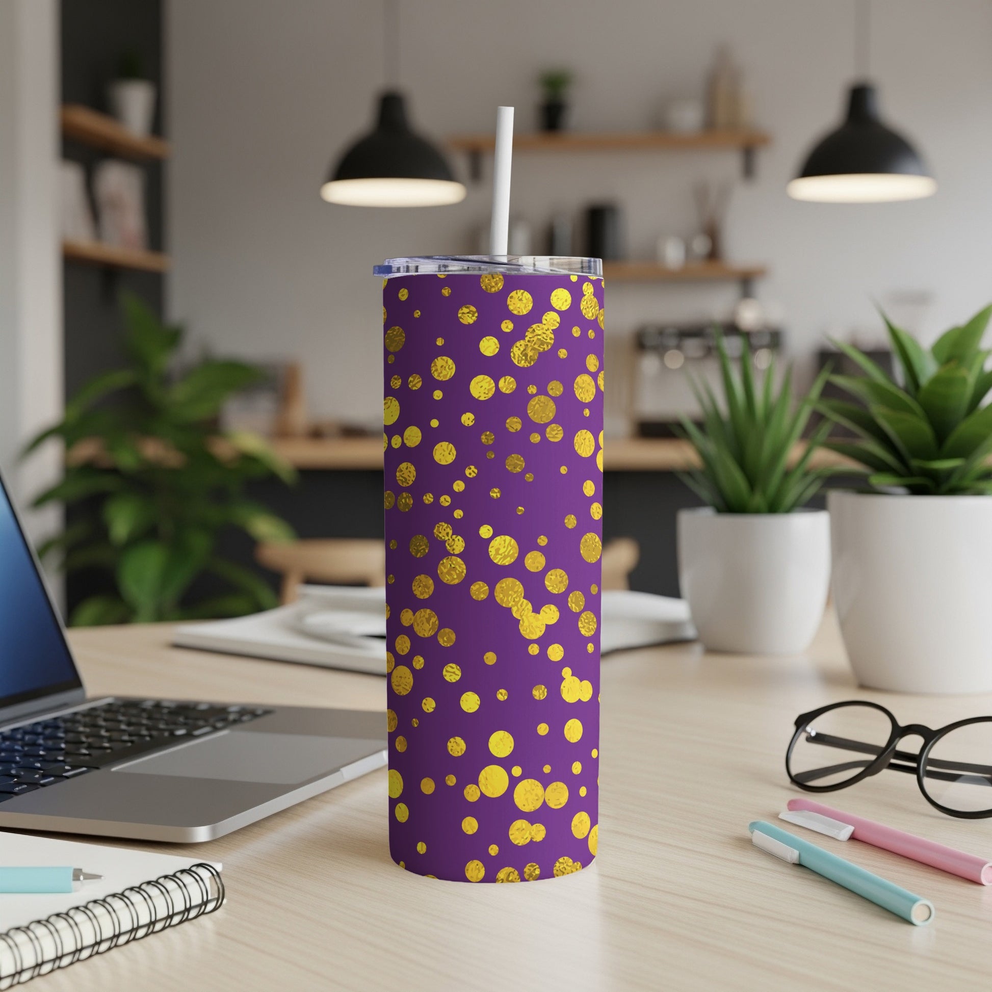 Purple tumbler with gold polka dots, featuring a white straw and lid.