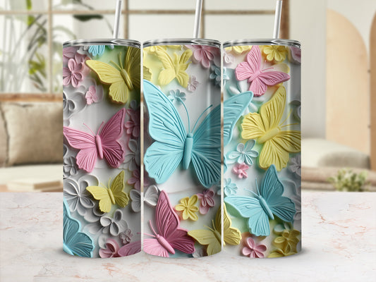 Three tumblers with pastel butterflies and floral designs.