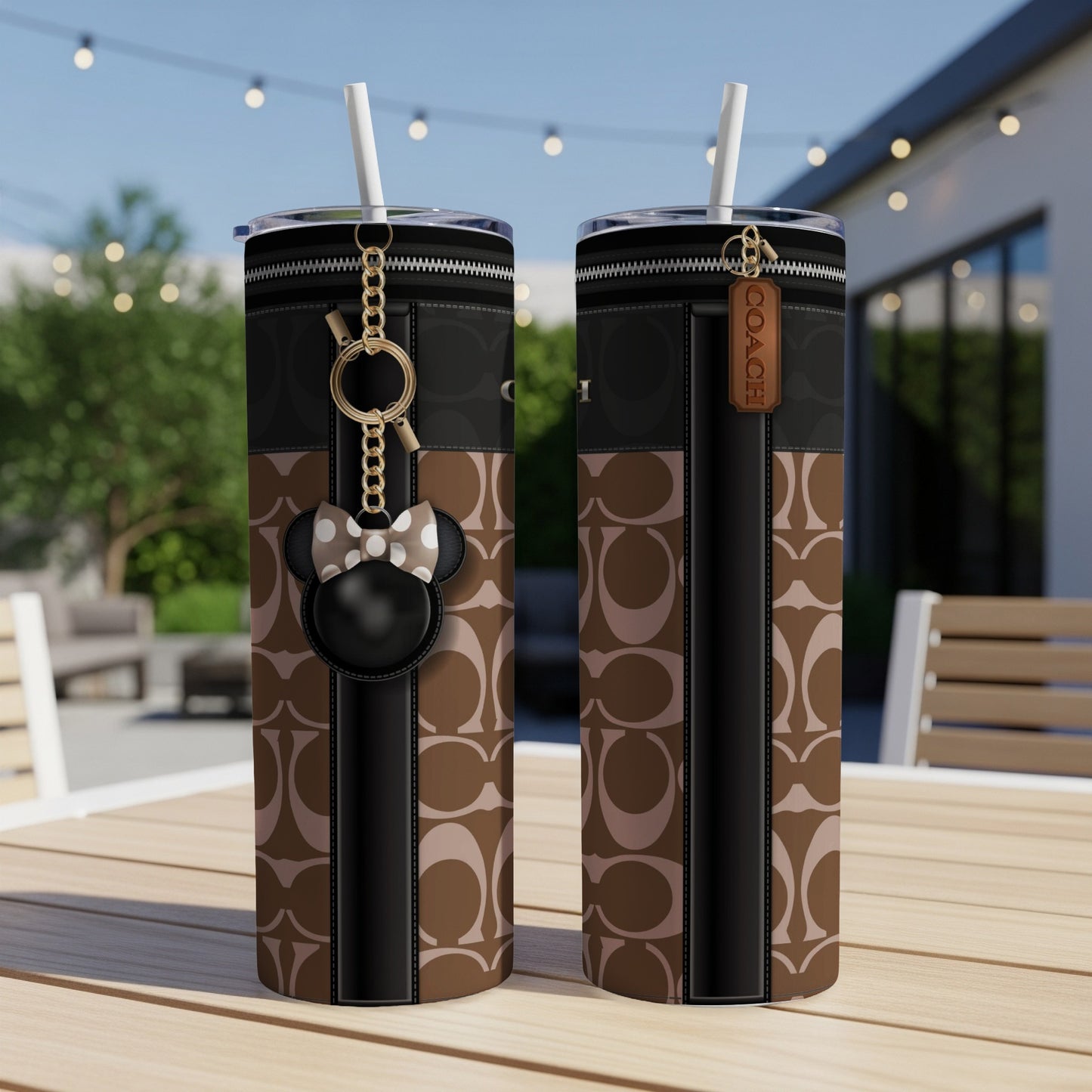 Two tumblers with Coach logo pattern and Minnie Mouse charm and tag.