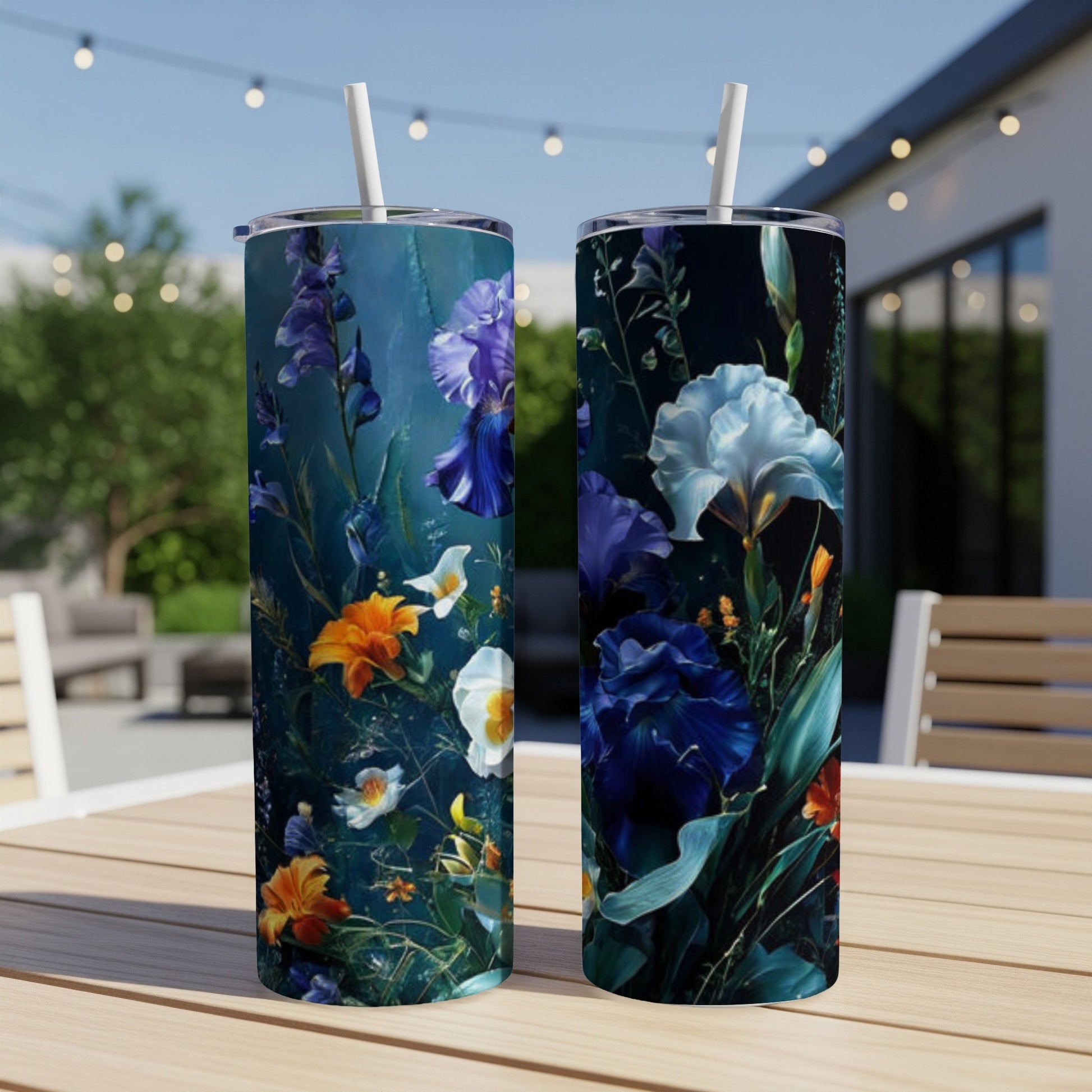 Two tall tumblers with a dark floral and iris pattern on a wooden table.