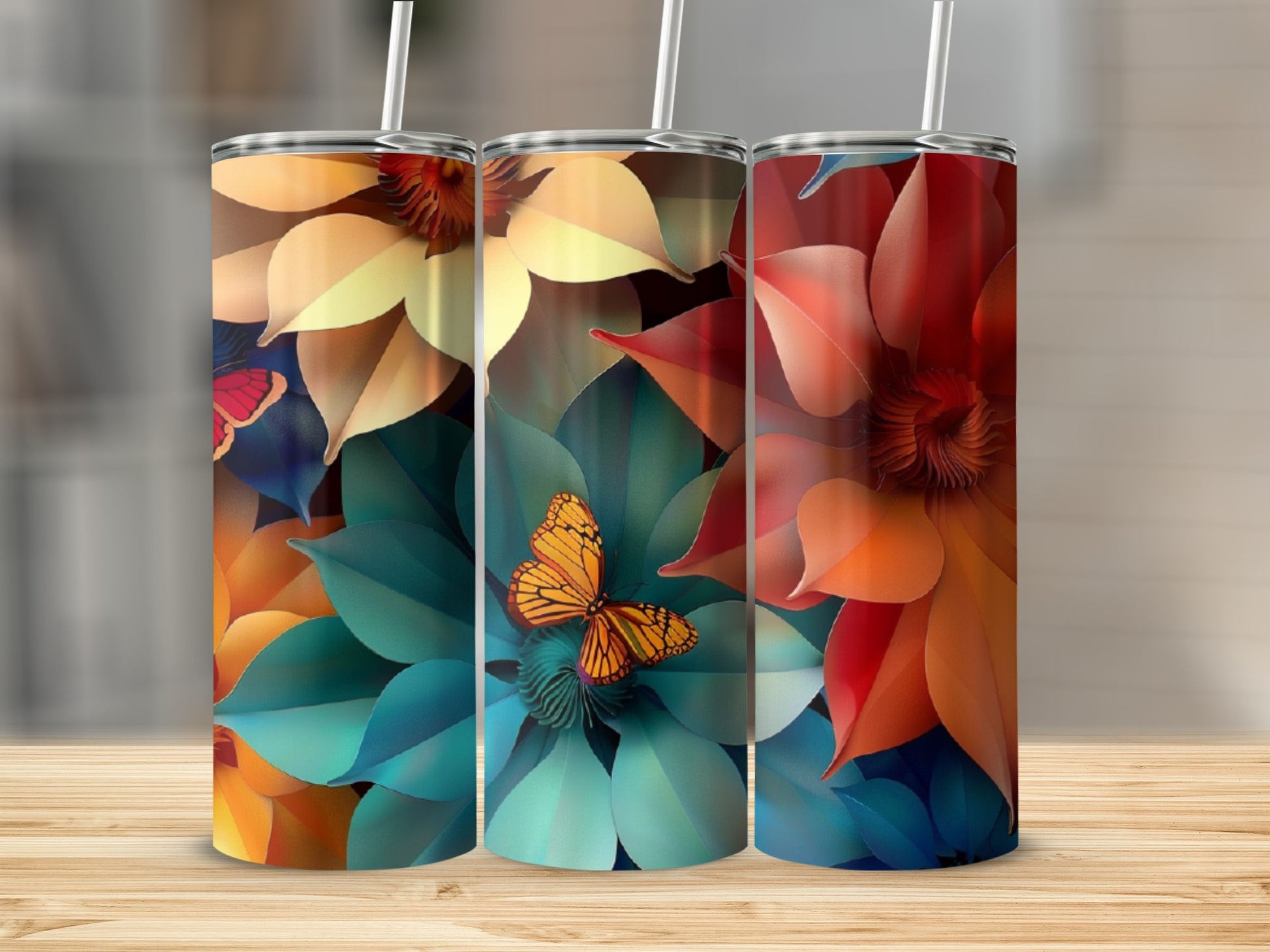Three tumblers with colorful floral and butterfly designs.