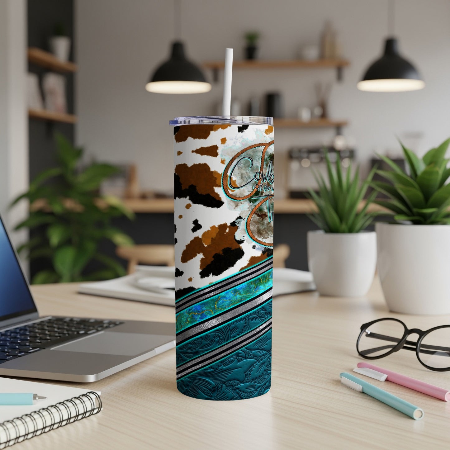 Cowgirl themed tumbler with cow print and turquoise accents.