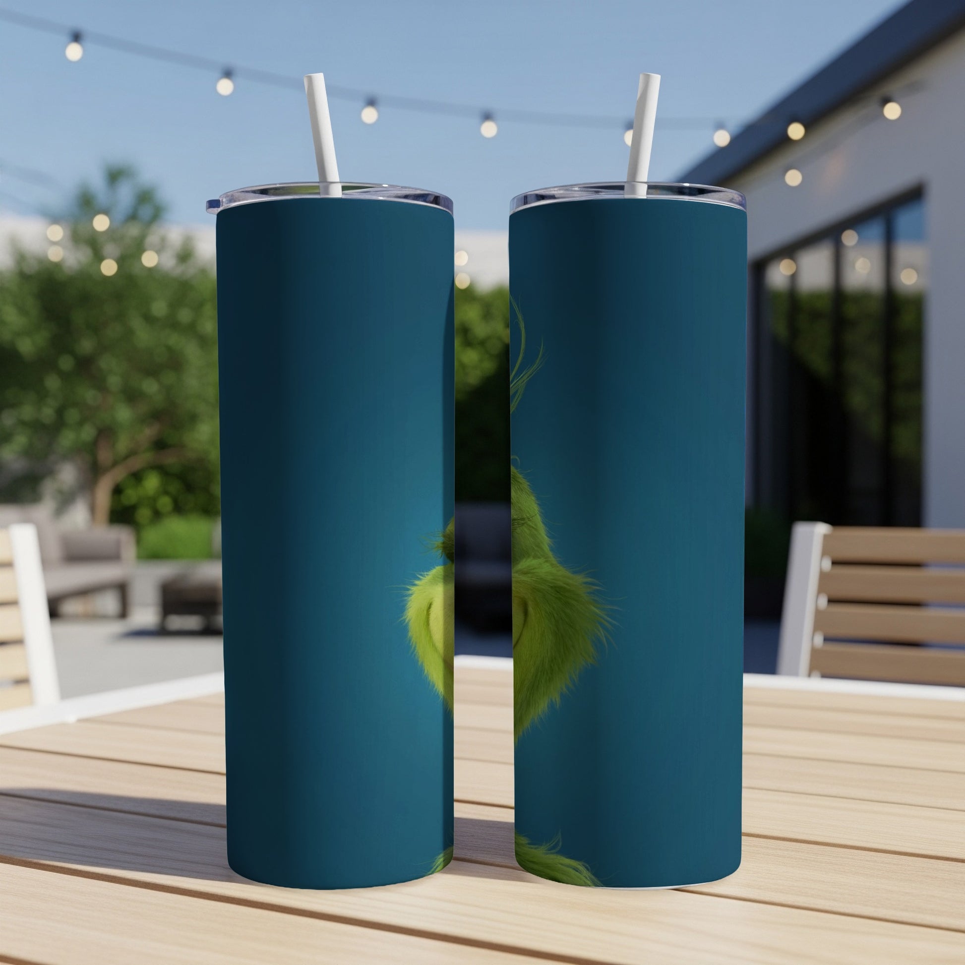 Two tall tumblers featuring the Grinch's green fur and face against a blue background.