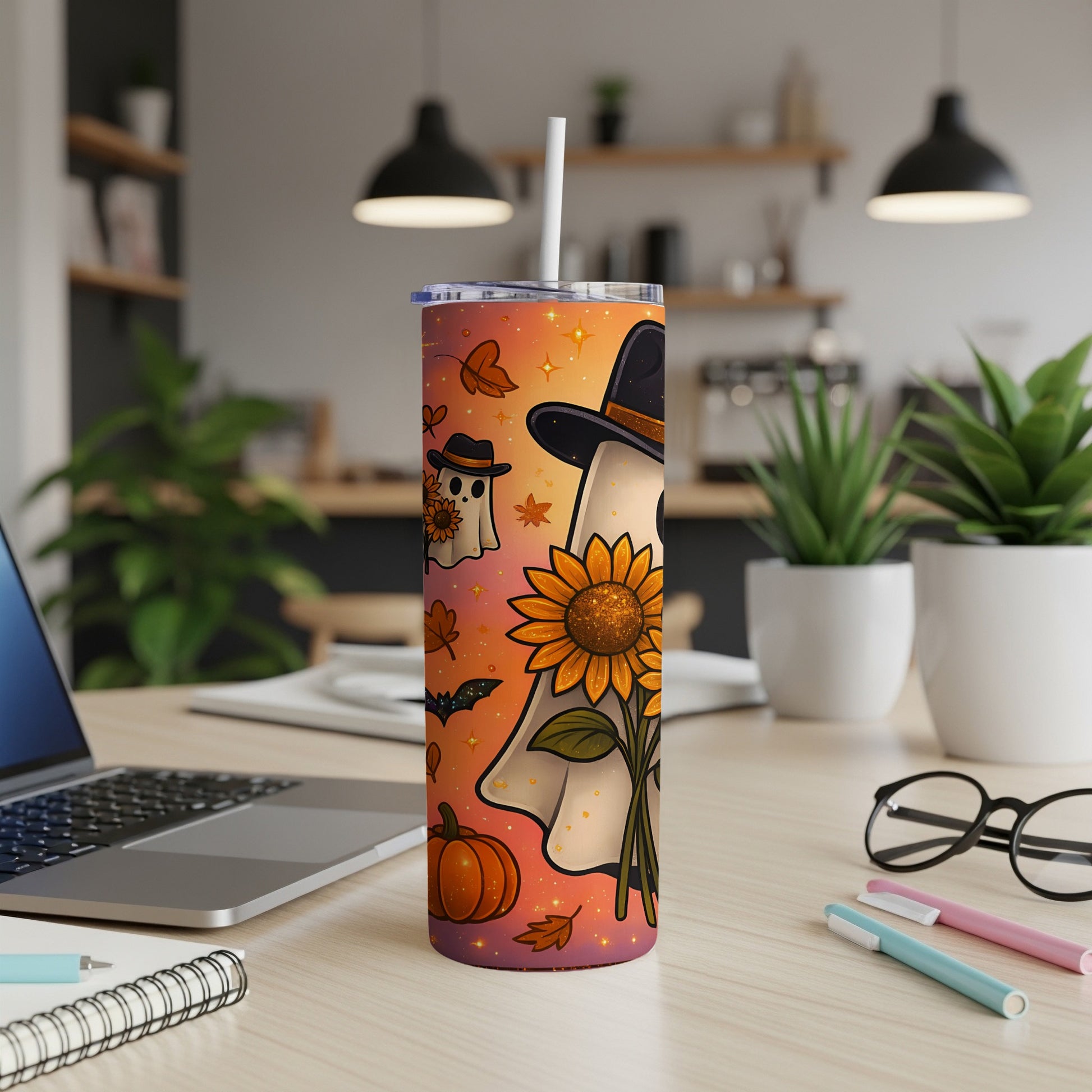 Tumbler with ghosts, sunflowers, pumpkins, bats, and autumn leaves on an orange gradient.