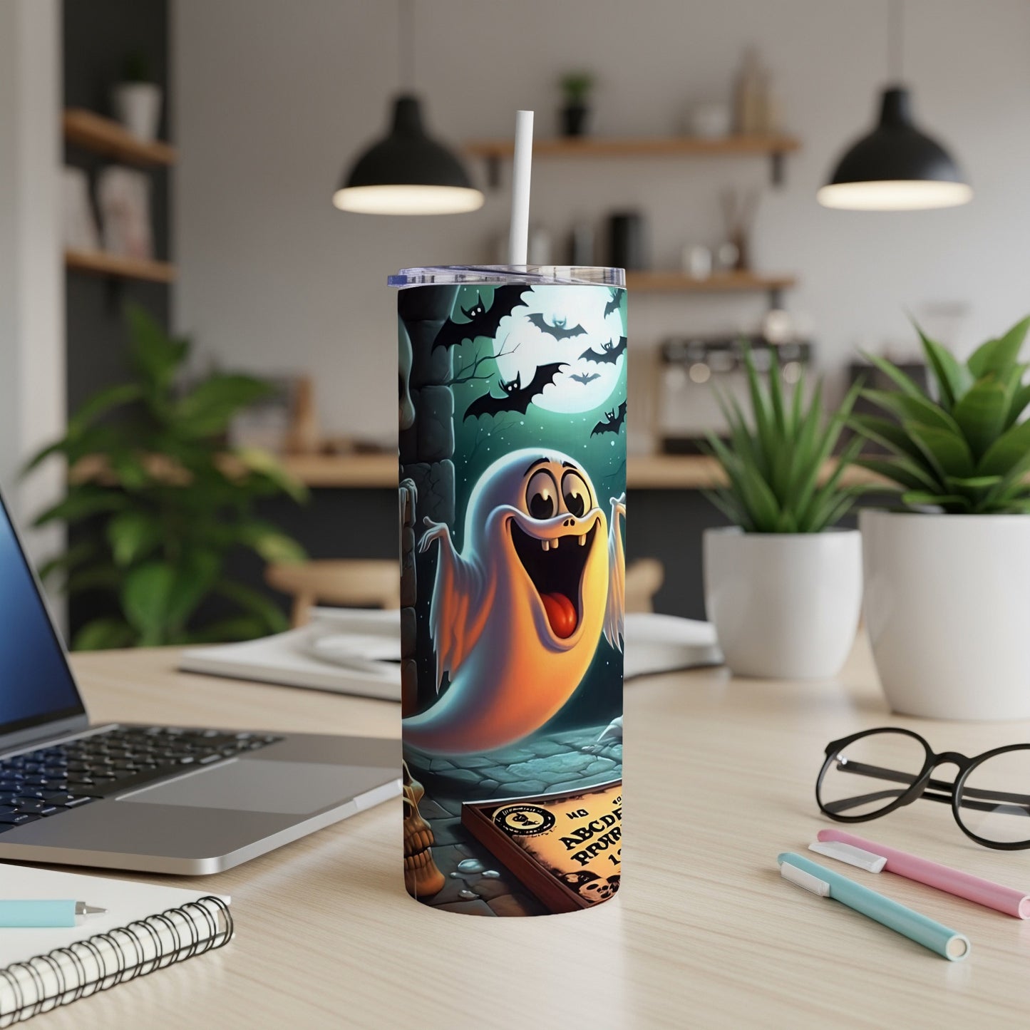 Tumbler with a cartoon ghost, bats, and a Ouija board on a spooky night scene.