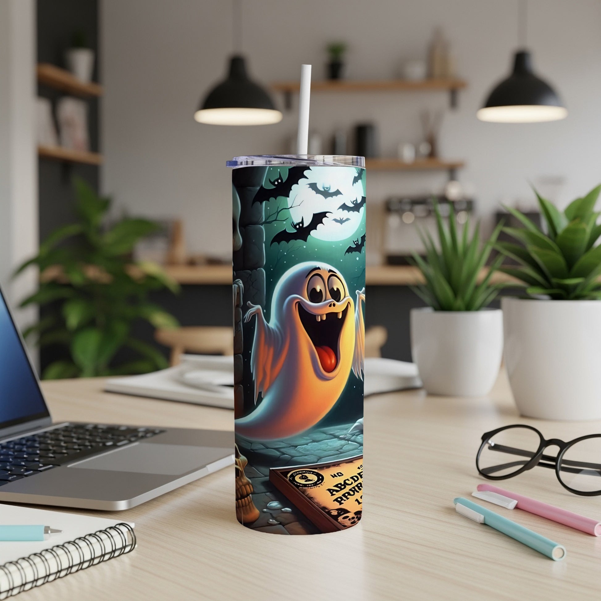 Tumbler with a cartoon ghost, bats, and a Ouija board on a spooky night scene.