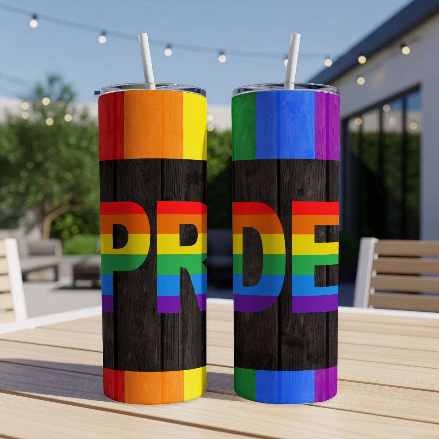 Two tall tumblers with rainbow Pride flag design on dark wood background.