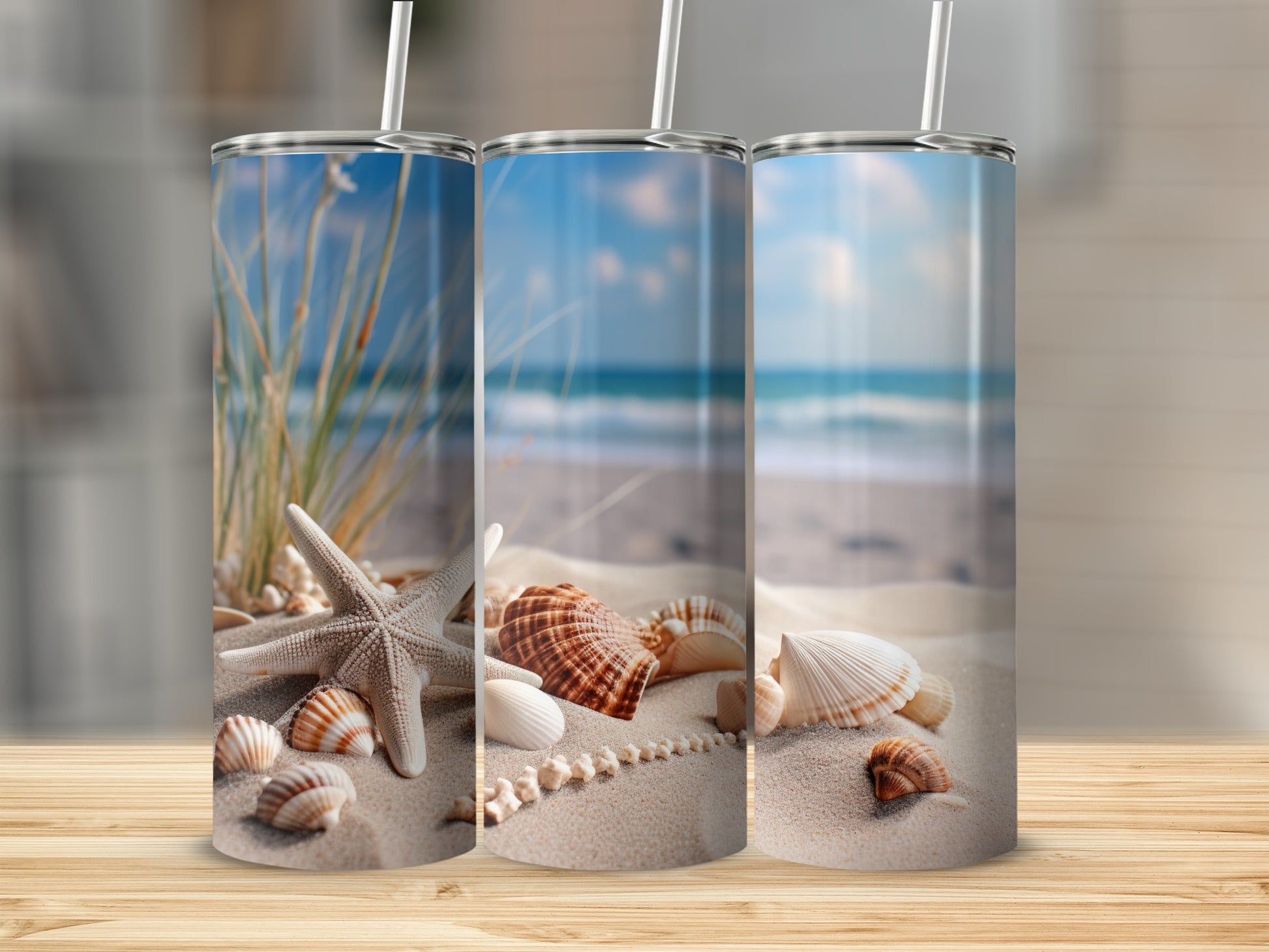 Three tumblers featuring a beach scene with shells and starfish.