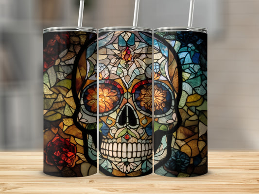 Stained glass sugar skull tumbler with floral accents on a wooden surface.