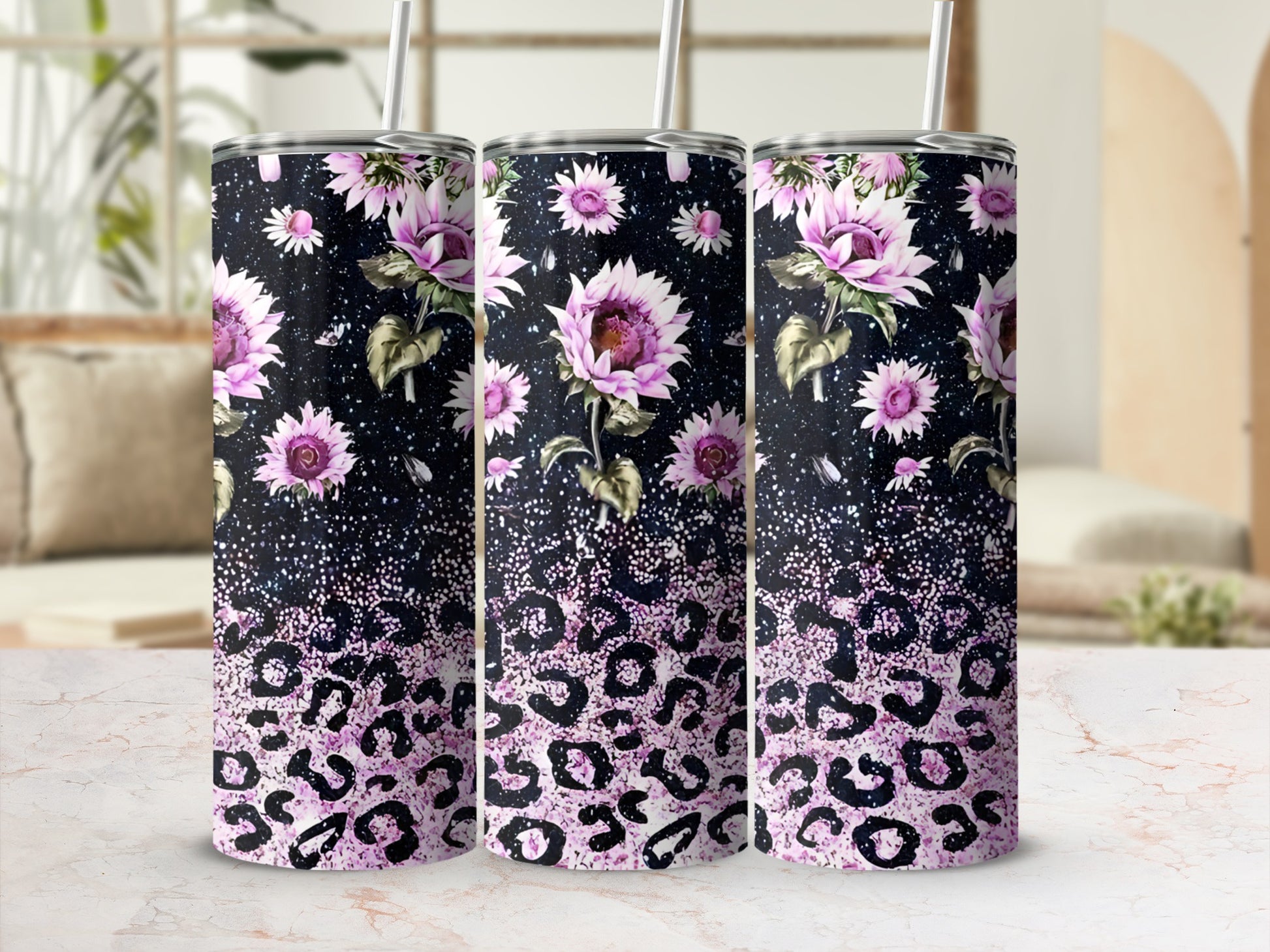 Three tumblers with floral and leopard print designs on a speckled background.