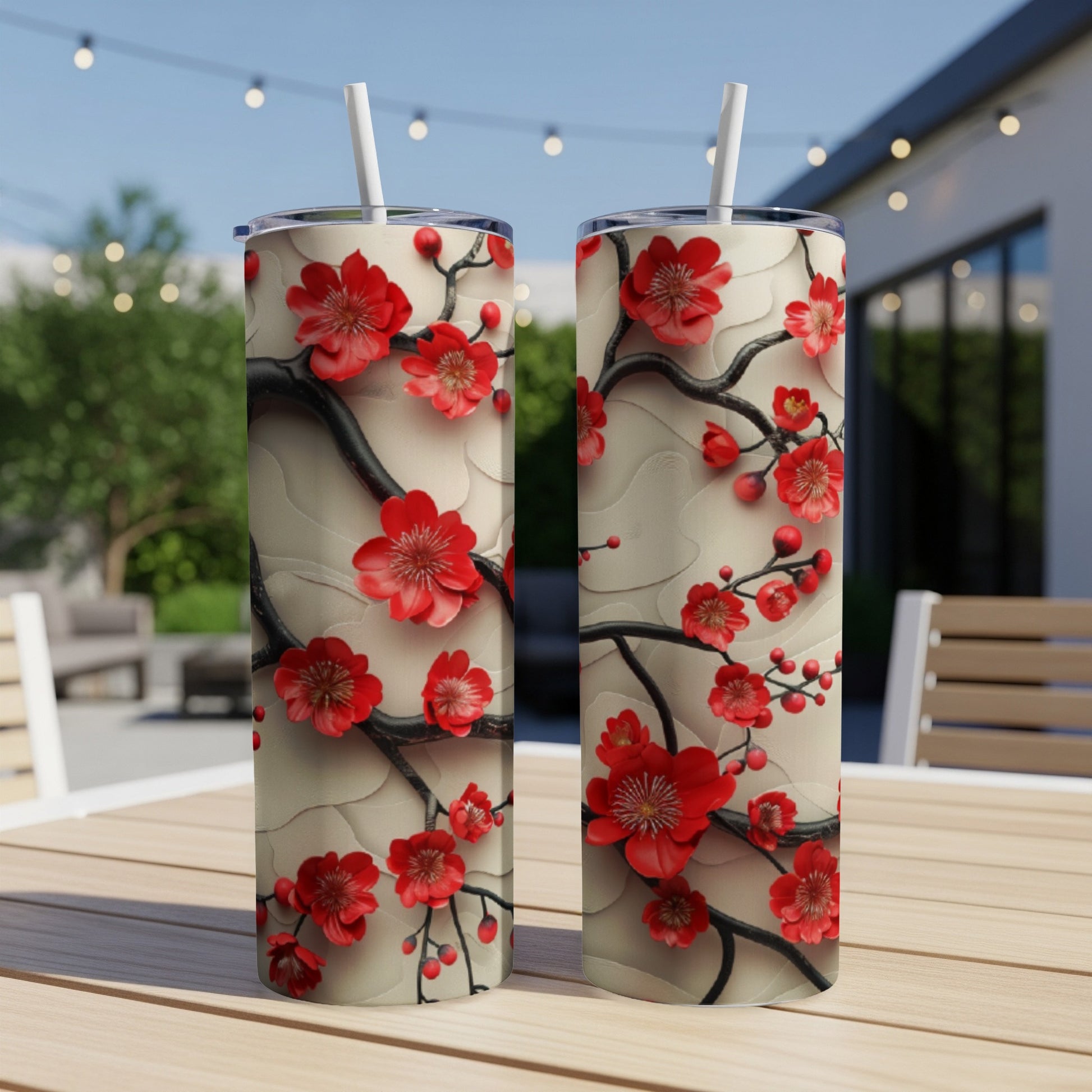 Two tall tumblers with red cherry blossoms and brown branches on a textured background.