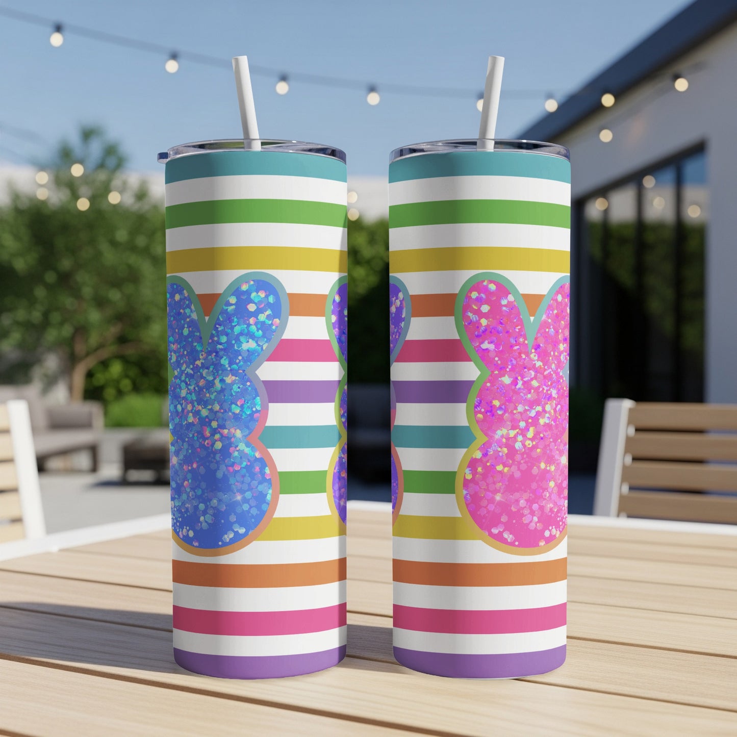 Two glittery bunny-shaped Easter tumblers with colorful stripes.