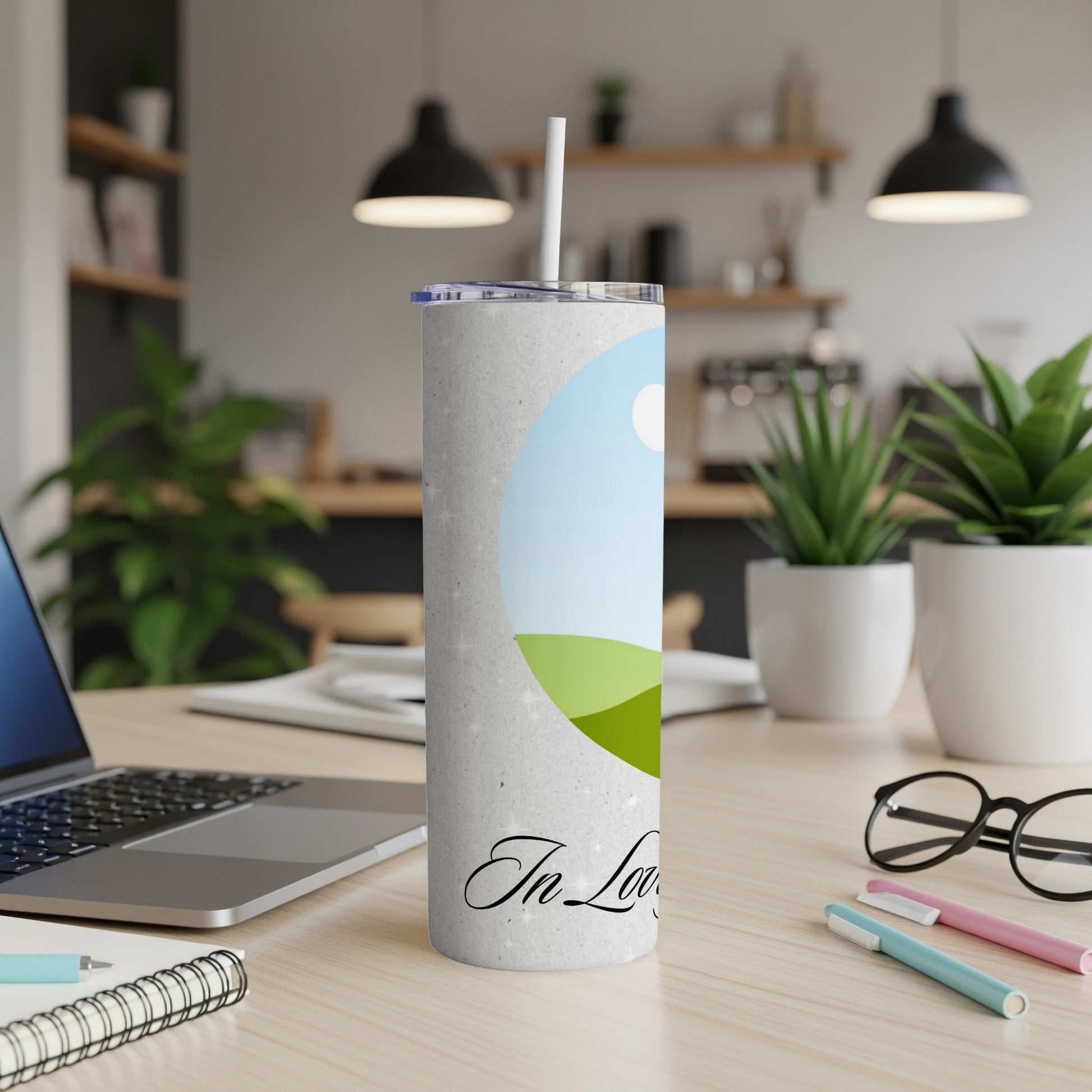 Textured tumbler with a sky and green hill design, featuring "In Love" script.