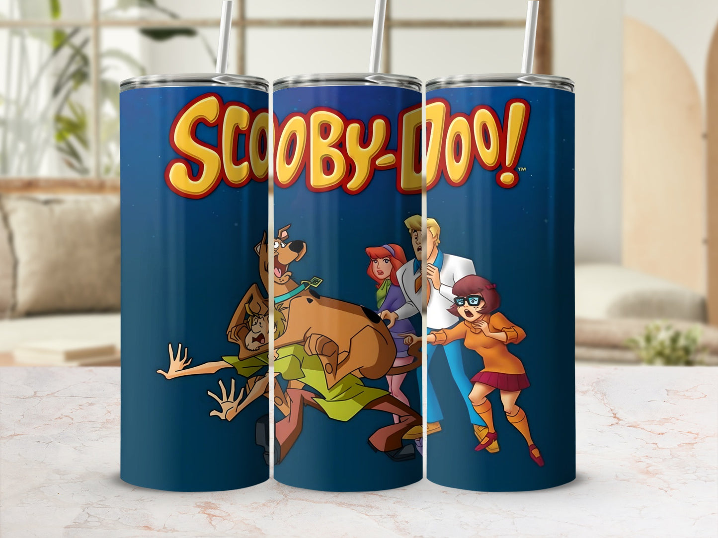 Scooby-Doo characters Fred, Daphne, Velma, and Scooby-Doo on a blue tumbler.