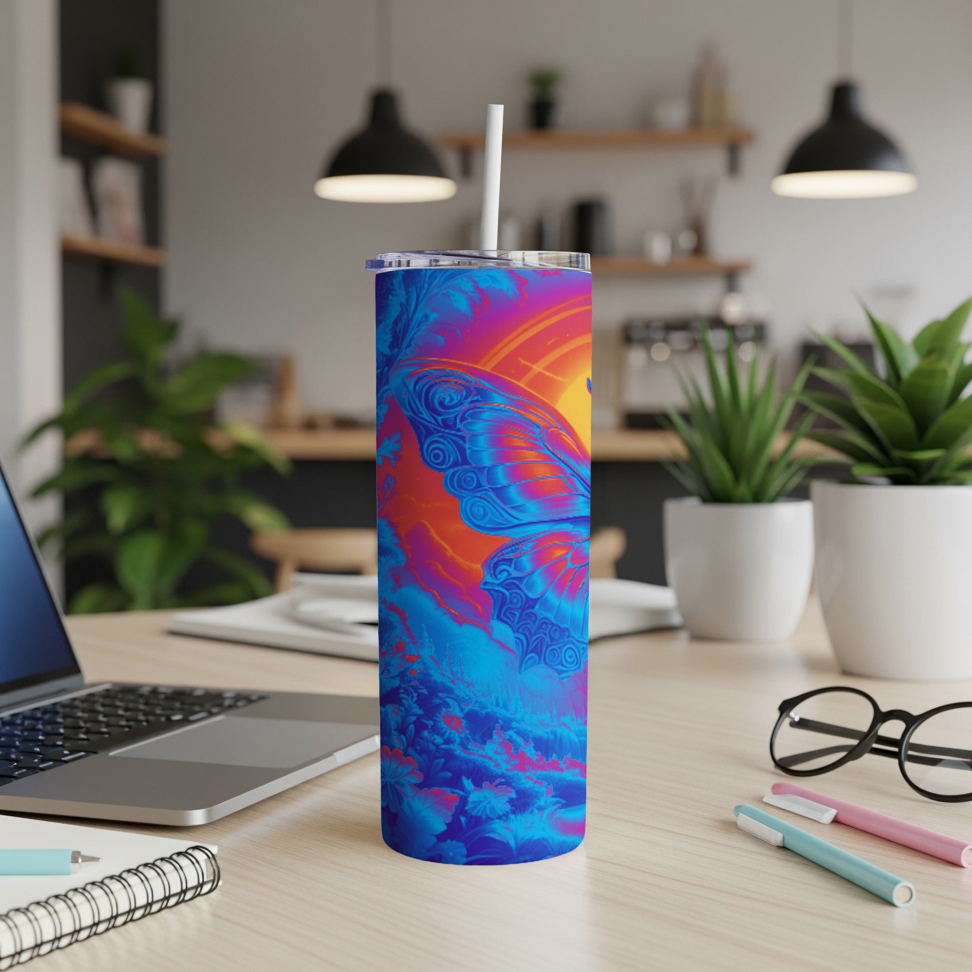 Blue and orange butterfly design on a tumbler with a straw.