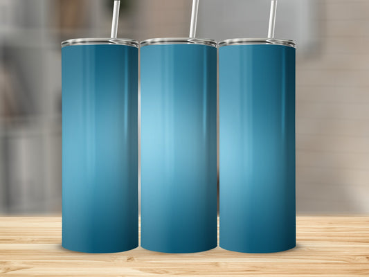 Three blue gradient tumblers with straws on a wooden surface.