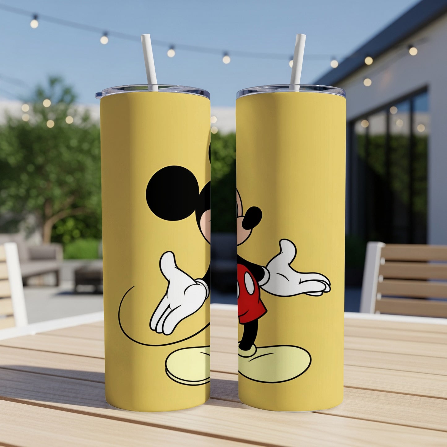 Two yellow tumblers featuring Mickey Mouse standing with arms outstretched.