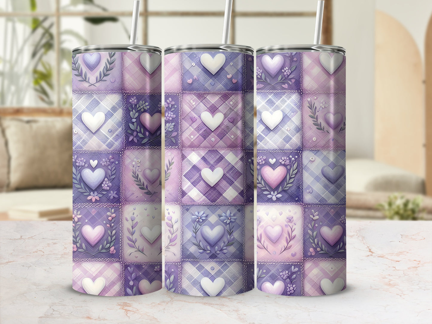 Three purple and pink patchwork heart tumblers with lids and straws.