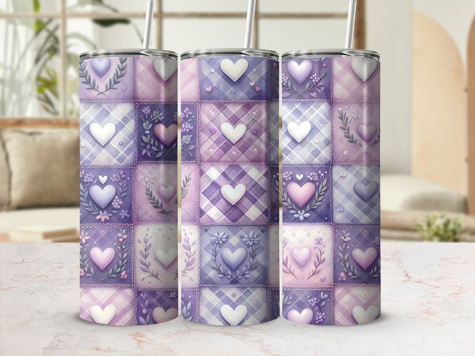 Three purple and pink patchwork heart tumblers with lids and straws.