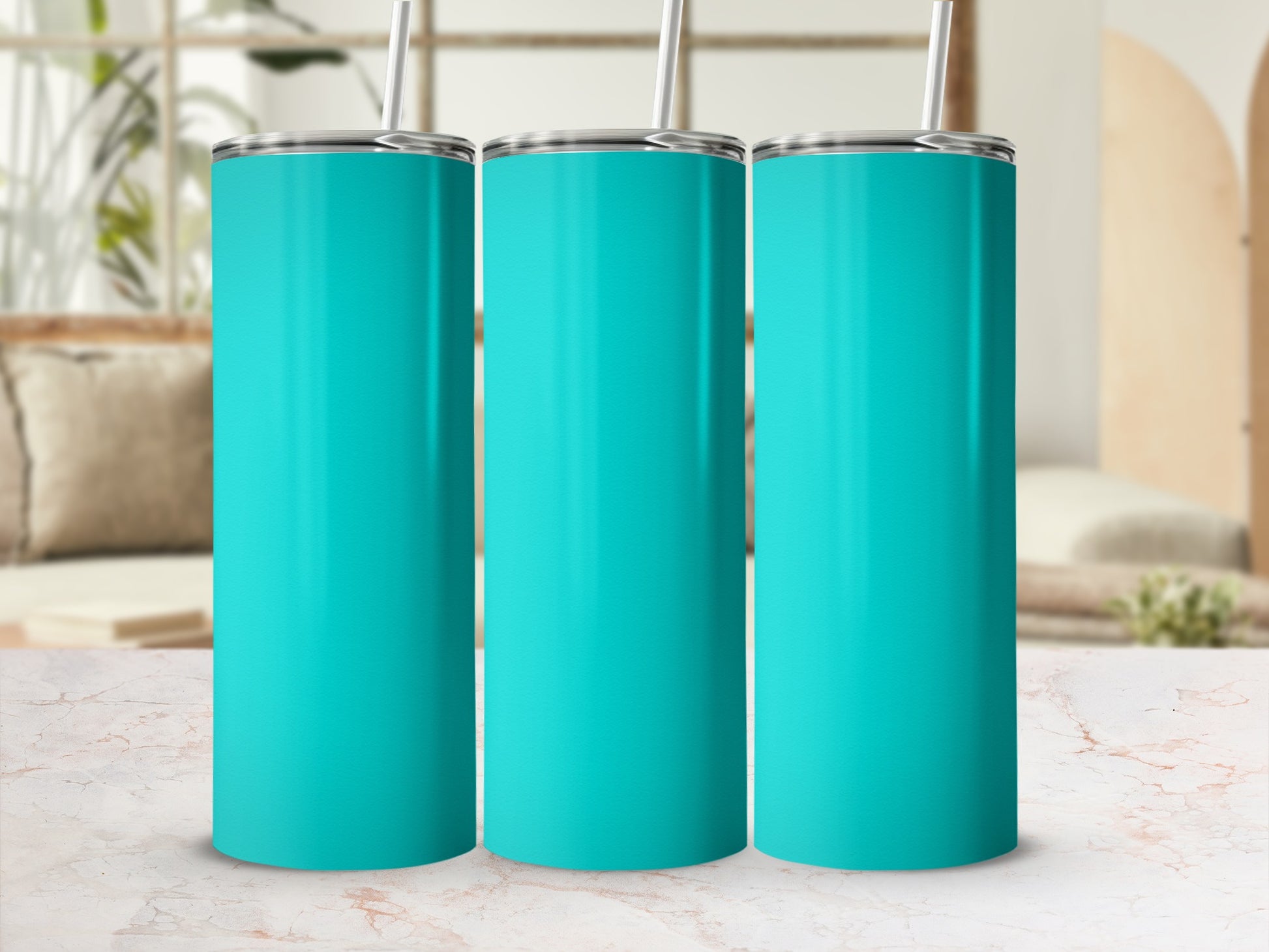 Three teal tumblers with straws on a marbled surface.