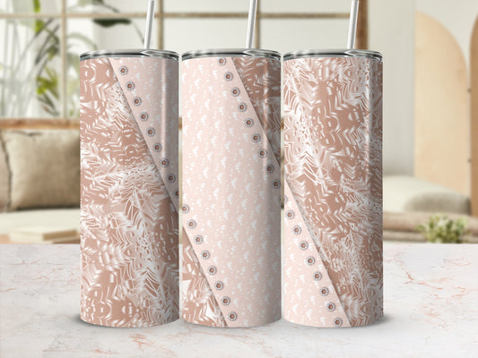 Three rose gold patterned tumblers with straw, displayed on a marble surface.