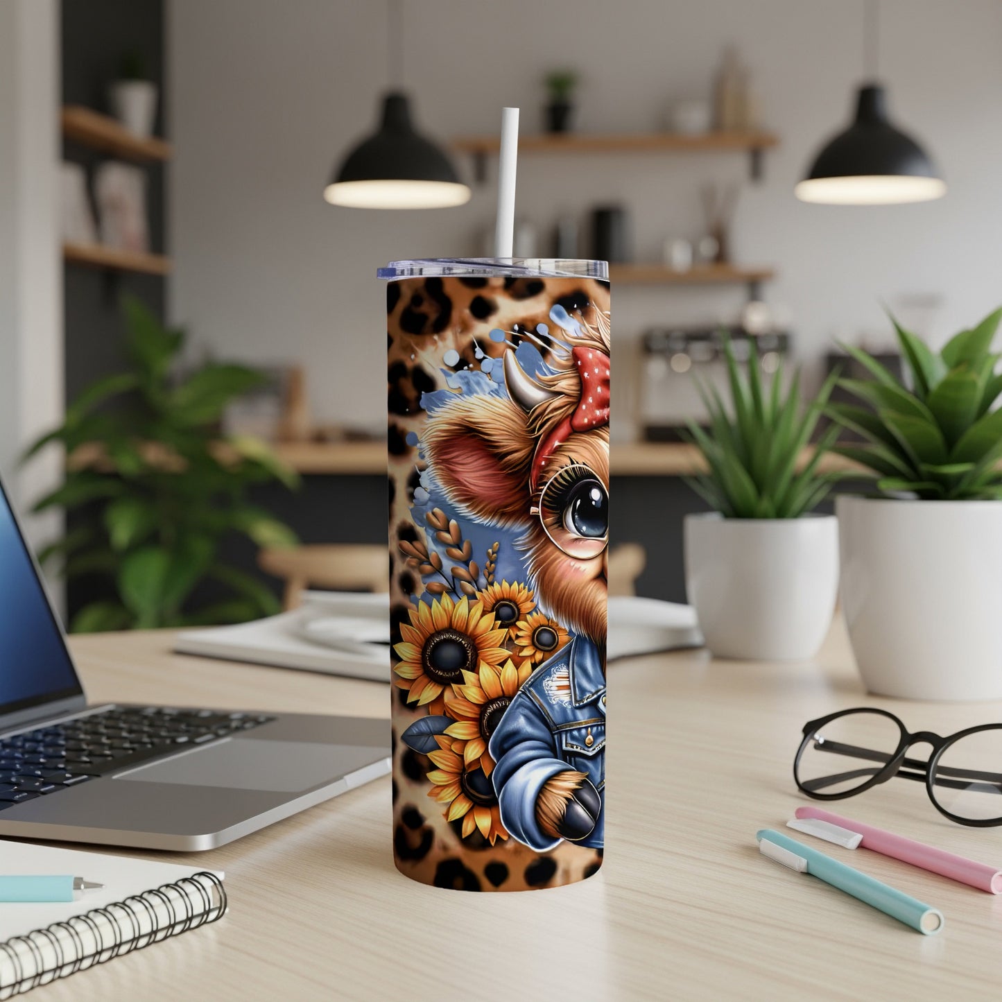Cute cow wearing denim jacket and bandana with sunflowers on tumbler.