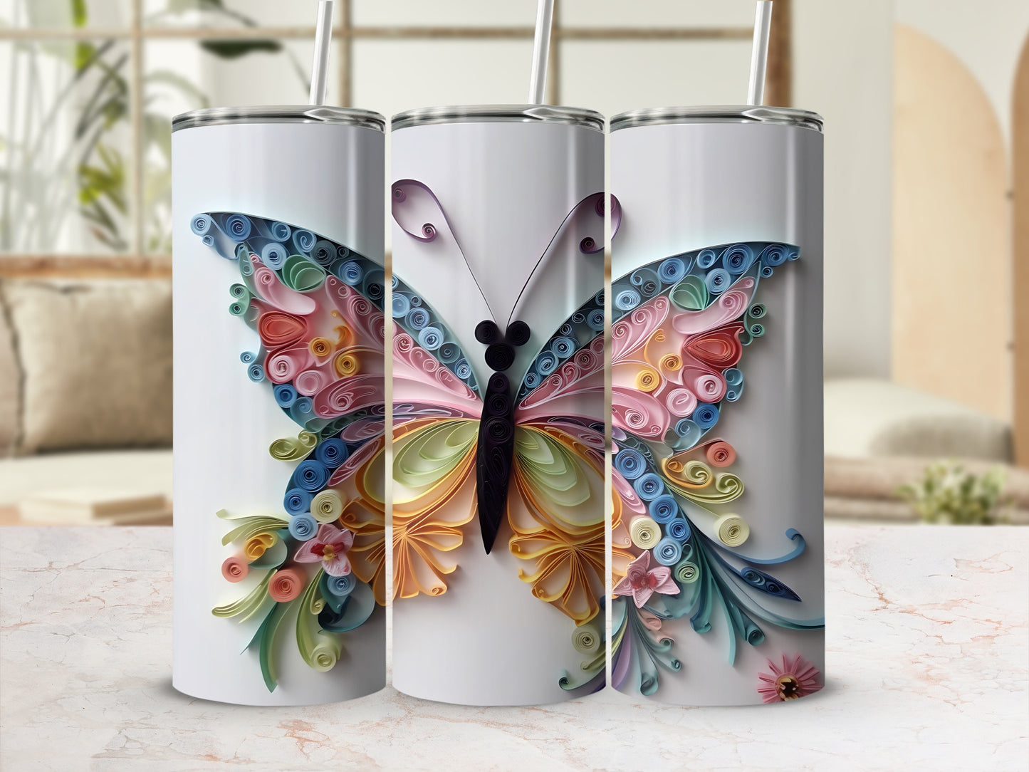 Three tumblers decorated with colorful quilled paper butterflies and floral accents.