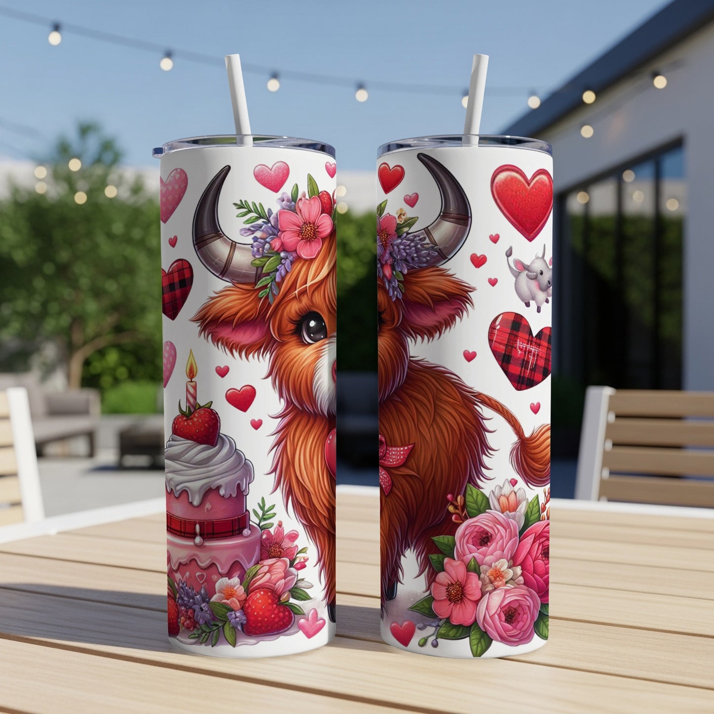 Two tumblers decorated with a Highland cow, hearts, and flowers.