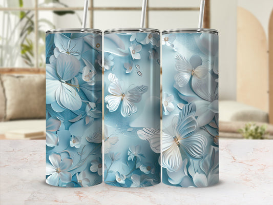 Three tumblers with a blue butterfly and floral design against a light background.