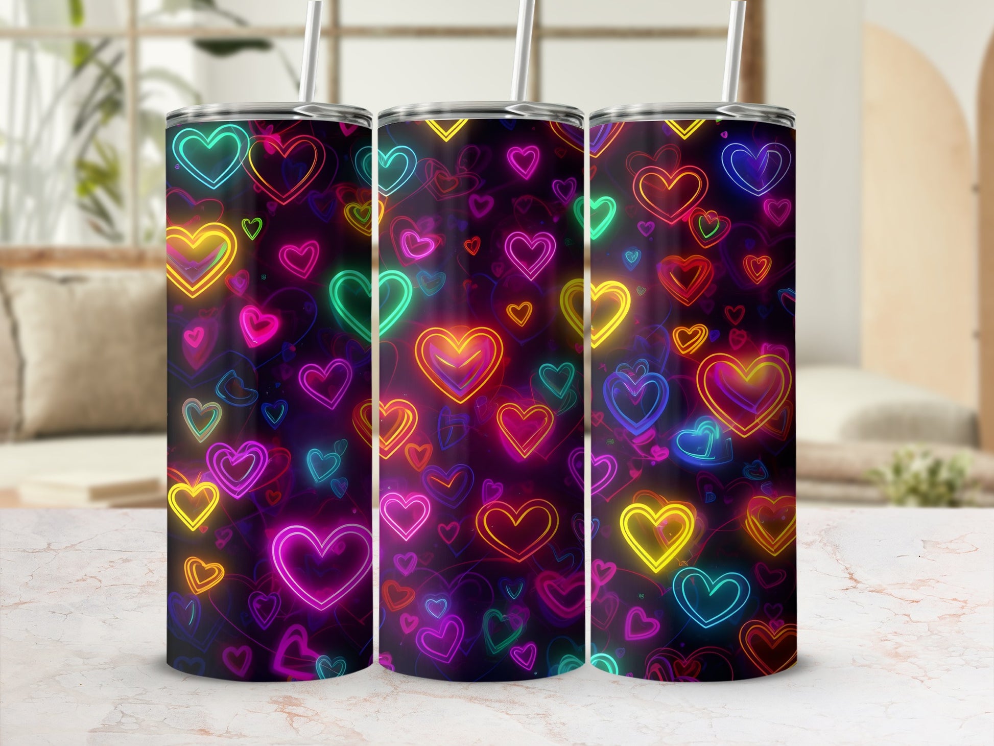 Three tumblers decorated with colorful neon heart patterns.