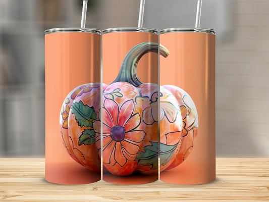 Orange tumbler with a floral pumpkin design.