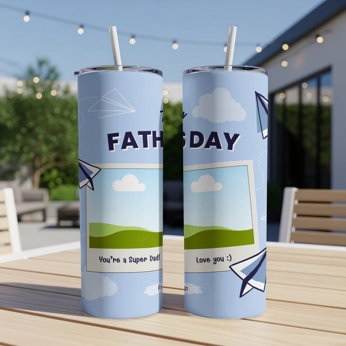 Two blue tumblers with "Fathers Day" text, airplane graphics, and photo frames.