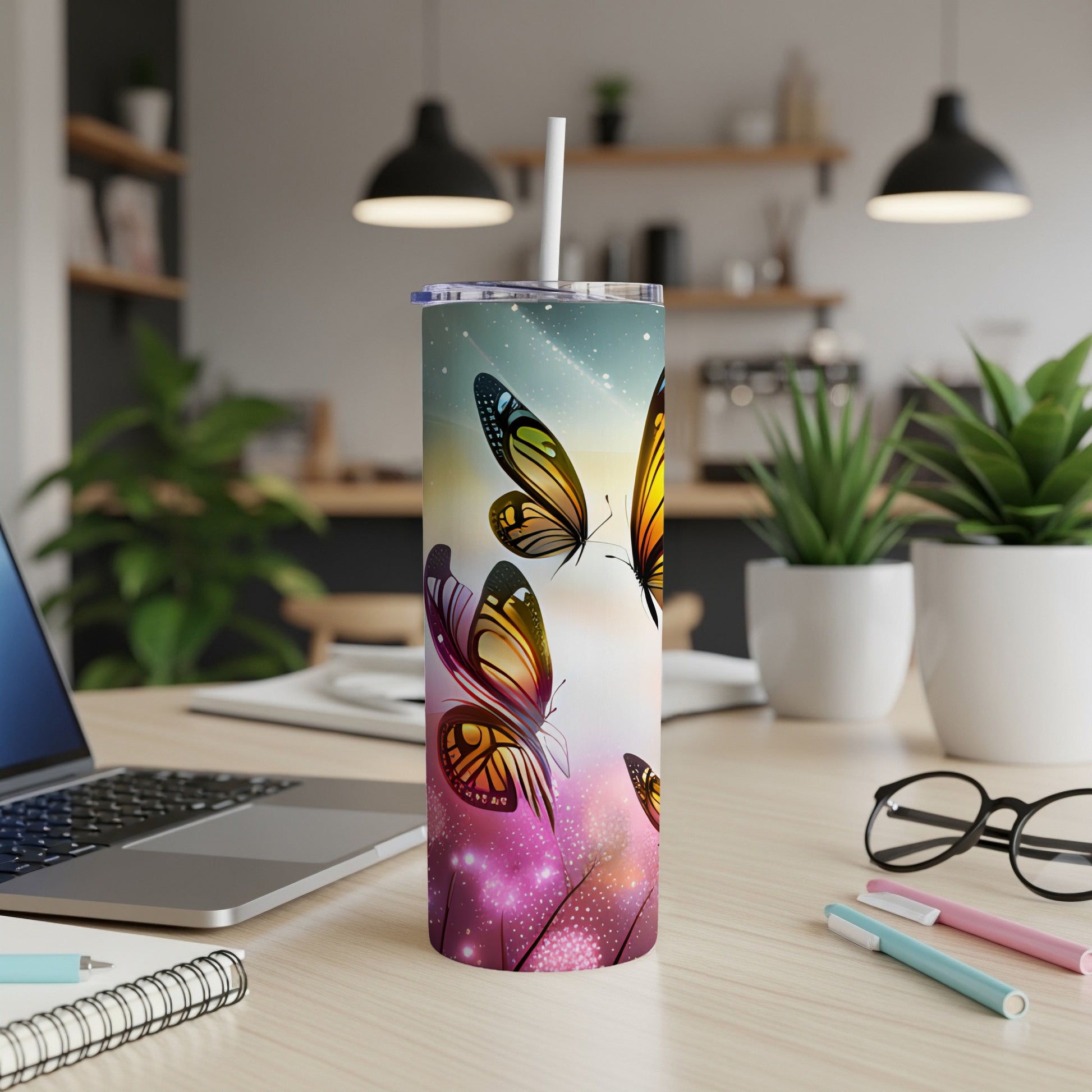 Colorful butterflies on a speckled background, a straw in the tumbler.