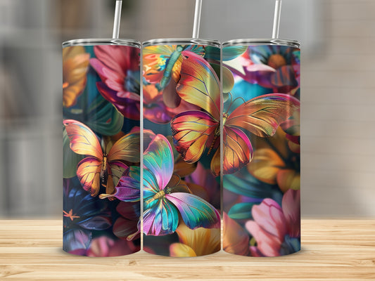 Three tumblers with colorful butterfly and floral designs displayed on a wooden surface.