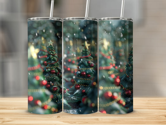 Three tumblers with festive Christmas tree designs and falling snow.