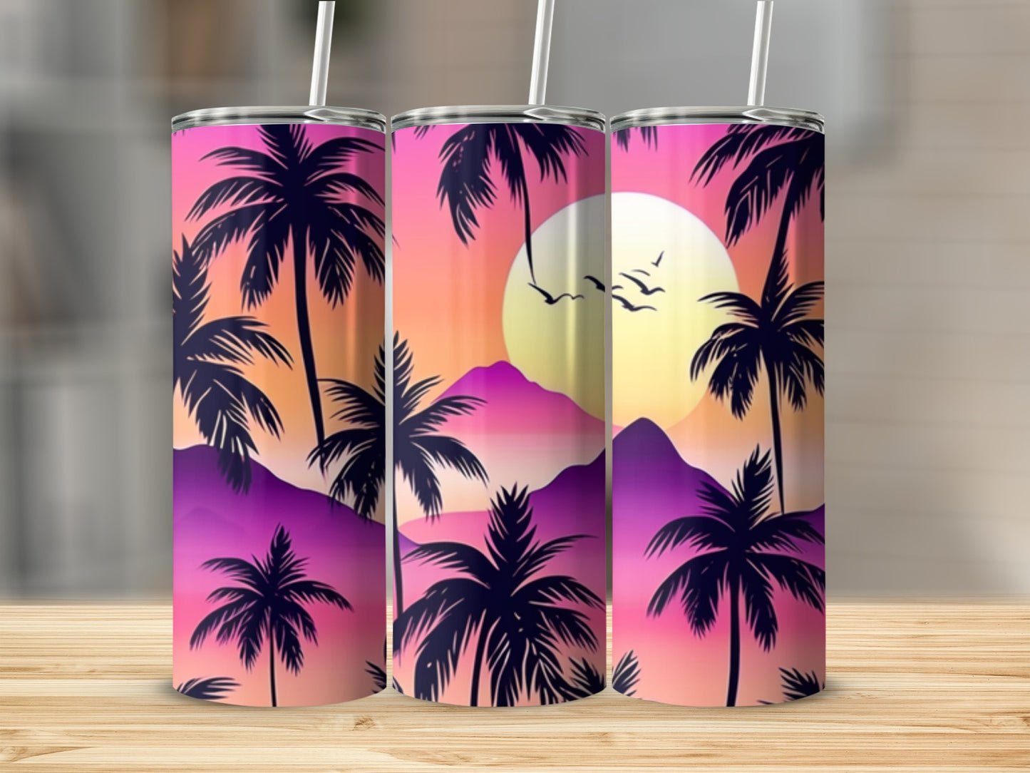 Three tumblers with sunset palm tree and mountain silhouette design.