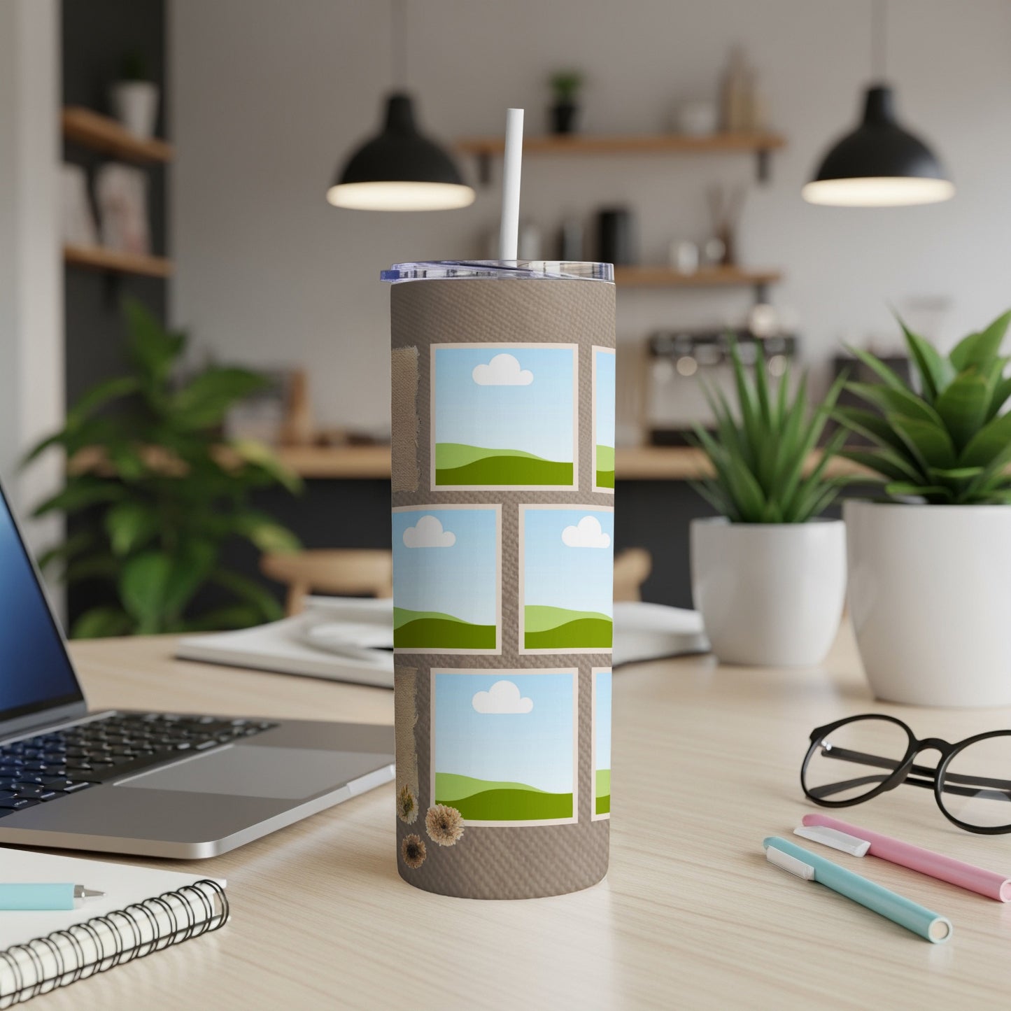 Tumbler with photo collage and straw, set on a desk.