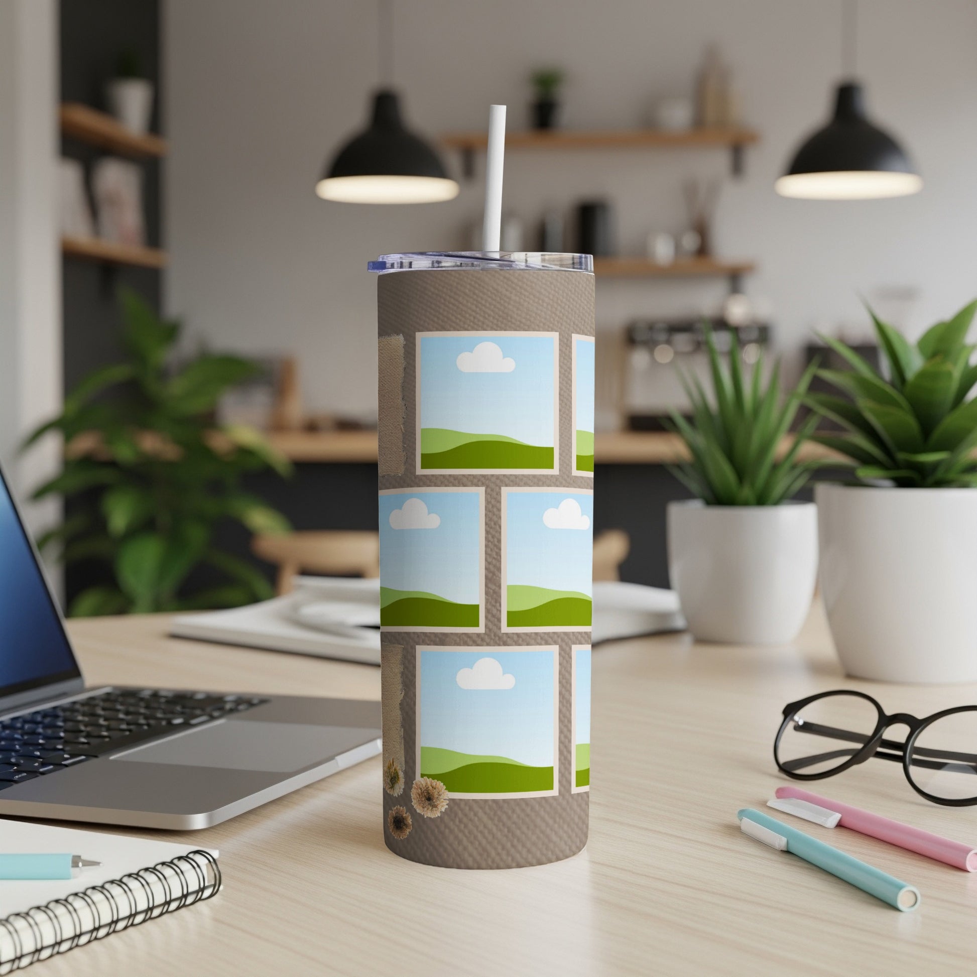 Tumbler with photo collage and straw, set on a desk.