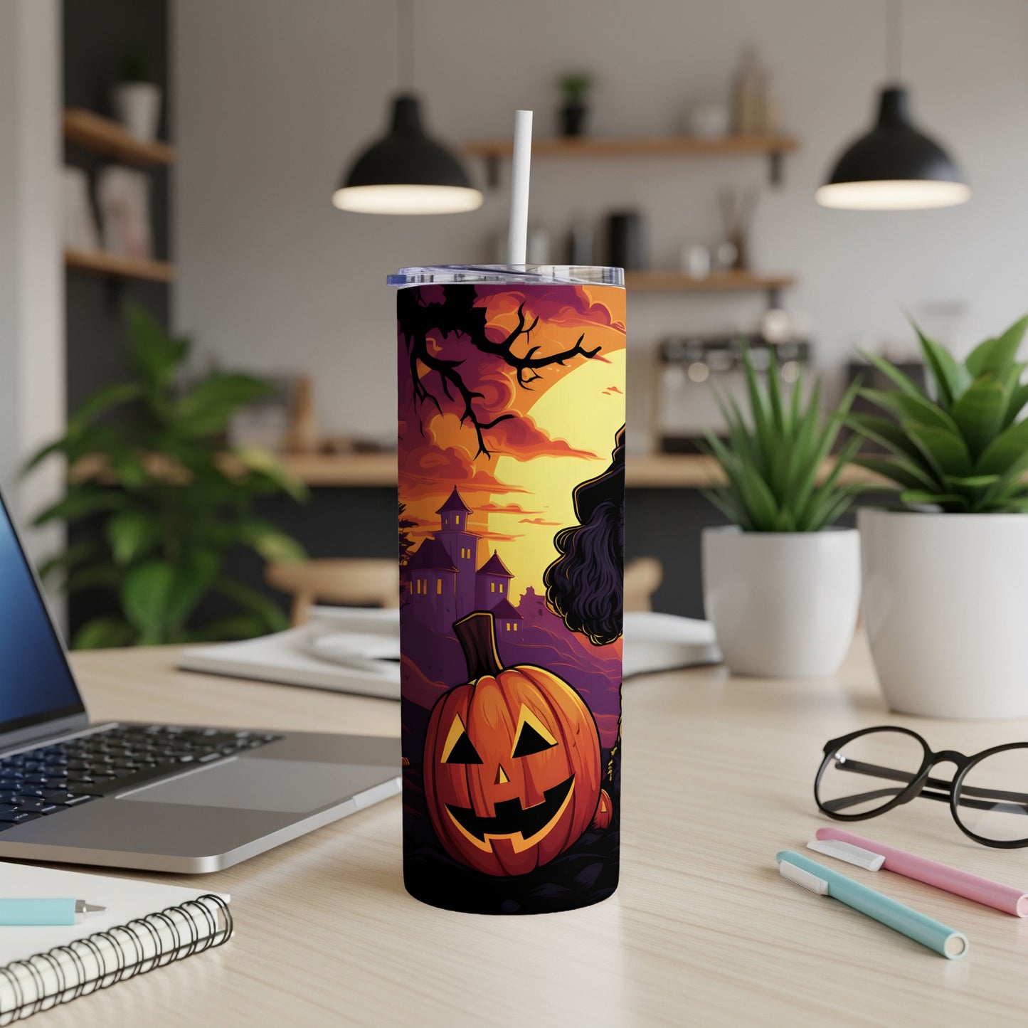 Halloween tumbler with jack-o'-lantern, haunted house, and witch against a sunset sky.