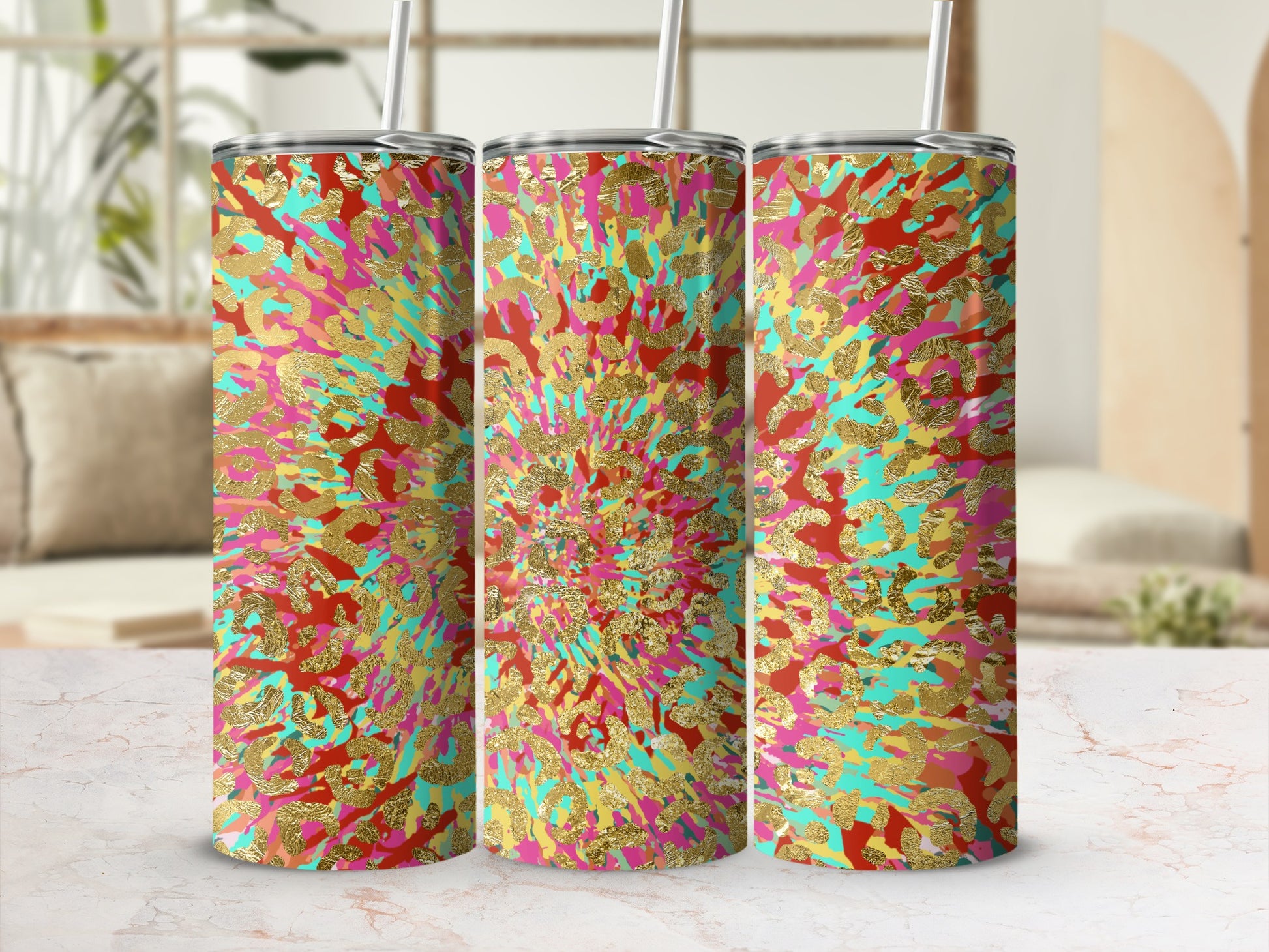 Three tumblers with a colorful abstract animal print and gold foil accents.