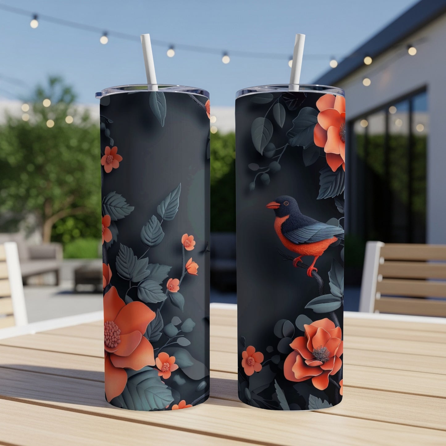 Two dark tumblers with coral flowers and a small bird on a table.