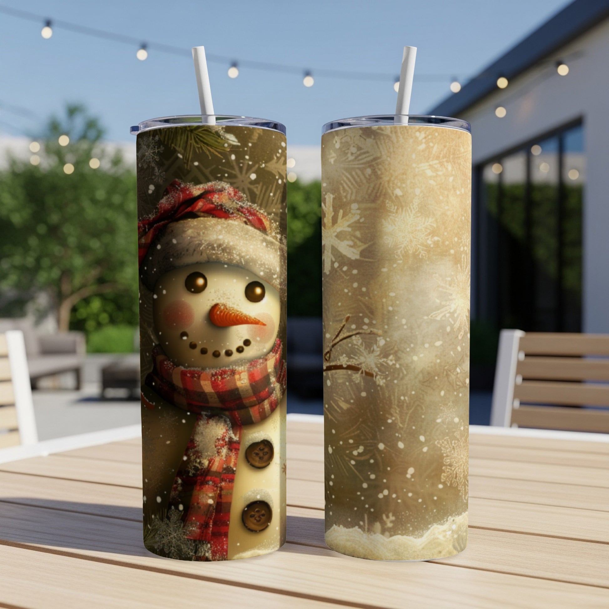 Two tumblers displaying a smiling snowman on one and snowflakes on the other.