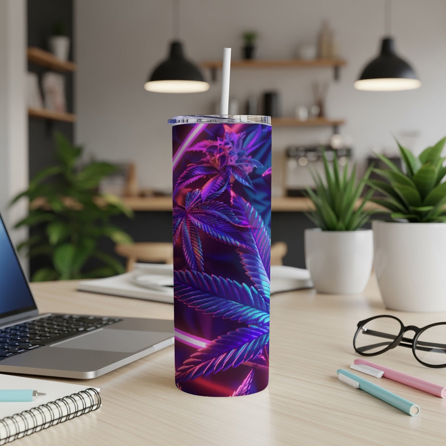 Cannabis leaf design on a blue and purple iridescent tumbler with a straw.