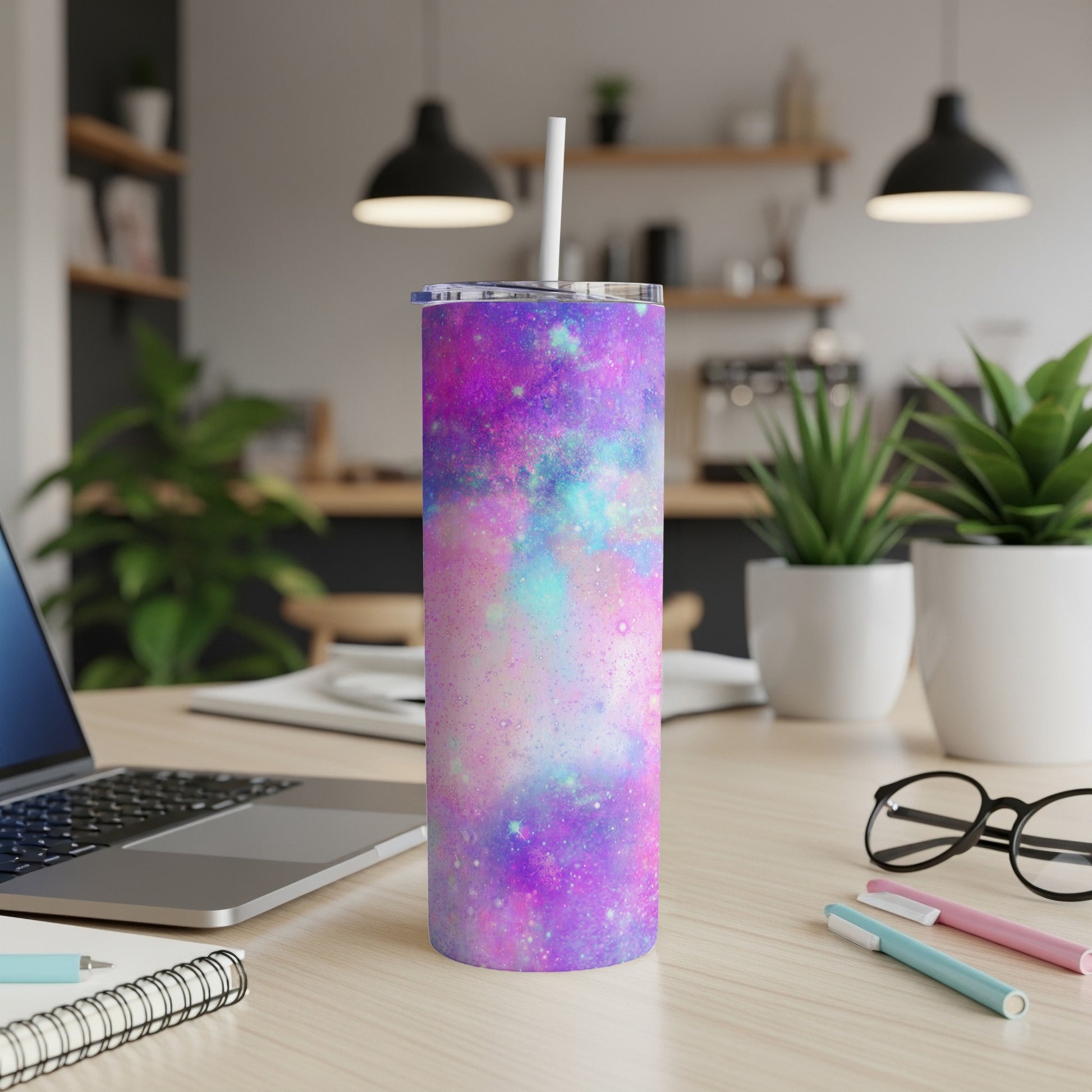 Tumbler with a purple, pink, and blue galaxy design and a white straw.