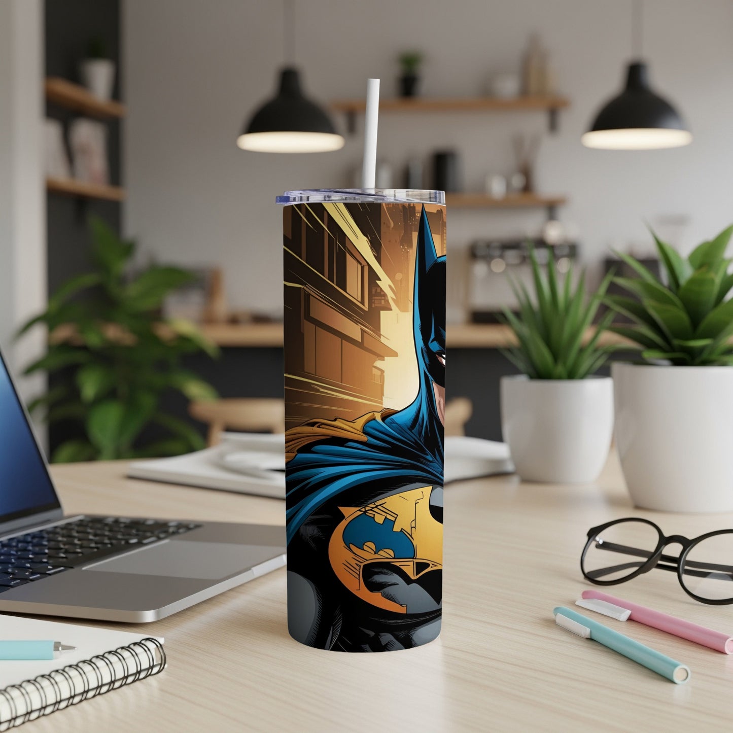 Batman tumbler with Gotham City cityscape, on a desk.