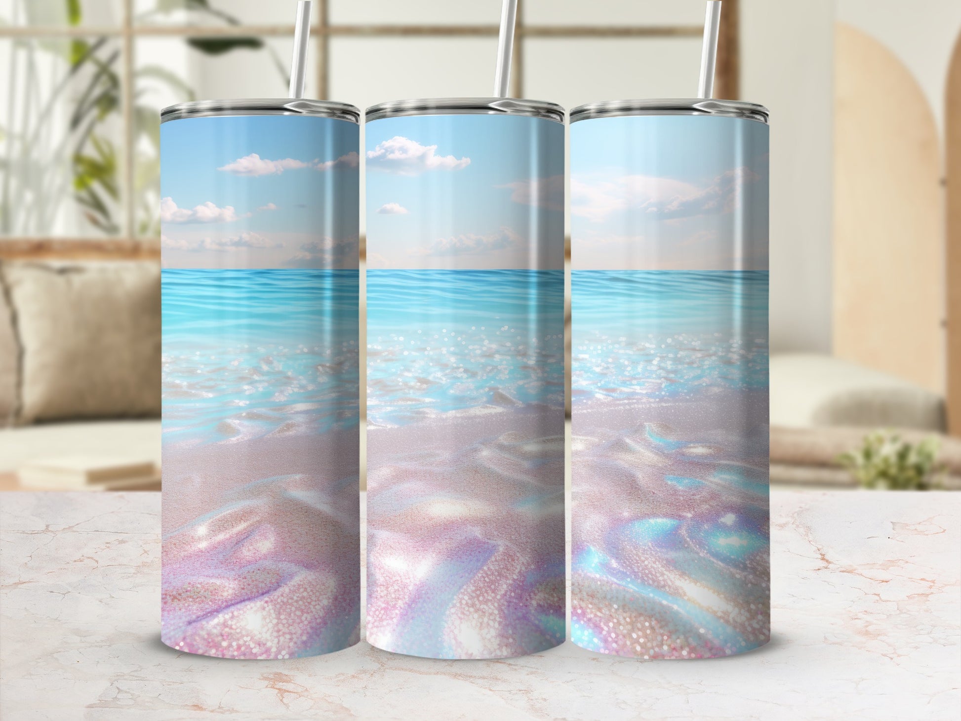 Three glittery tumblers with ocean and beach scene designs.