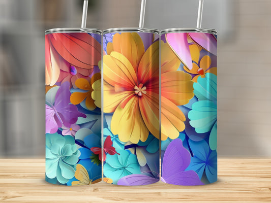 Three tumblers with colorful floral and butterfly designs on a wooden surface.